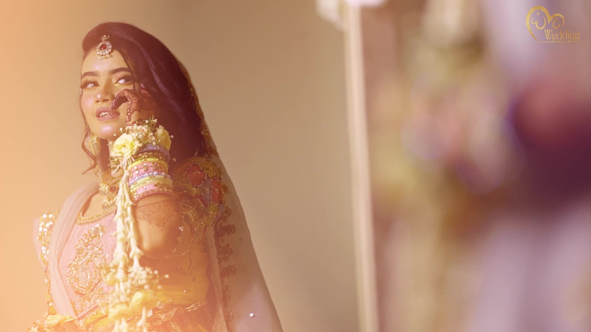Close-up of a bride with henna-decorated hands, from our bridal reel